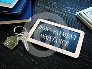 Down payment assistance phrase and house key. photo