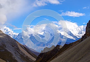 Down a screen valley towards a icey mountain range