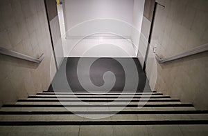 Down stairs., Interior office stairway,steps down perspective angle falling towards floor., entrance with steps down