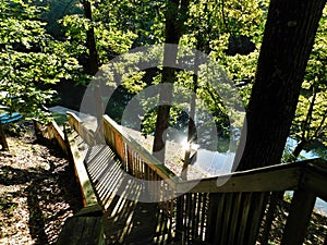 Down the stairs to the boat dock with sun reflection on water