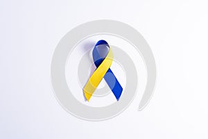 Down syndrome day with blue yellow ribbon awareness support patient with illness disability