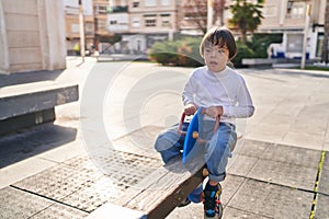 Down syndrome kid playing at park