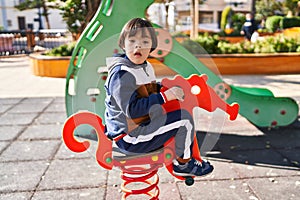 Down syndrome kid playing at park