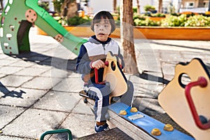 Down syndrome kid playing at park