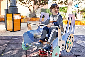 Down syndrome kid playing at park