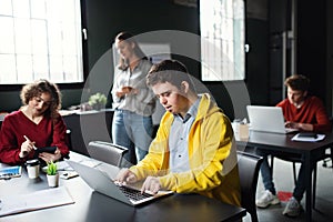 Down-syndrome man with laptop attending education class in community center, inclusivity of disabled person.