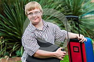 Down syndrome student with file and trolley. photo