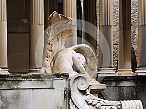 Downcast angel in front of the grave