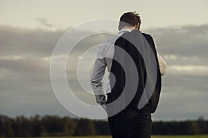 Downhearted businessman standing outdoors photo