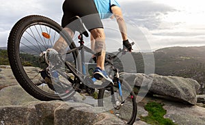 A downhill mountain biker drives down the rocks in Galicia.
