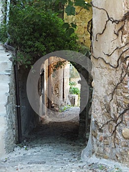 Downhill passageway between stone houses in Bussana Vecchia