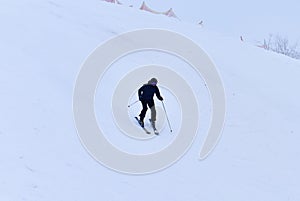 Downhill skier. Snowboarders and skier ride on snow in the mountains. Downhill ride. Adventure skiers season. Skiing and