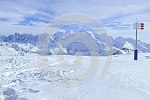 Downhill skiing in high Alps, snowy mountain peaks panorama