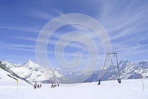 downhill skiing on prepared ski slope in Swiss Alps