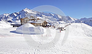 Downhill slope and apres ski mountain hut with restaurant terrace in the Italian Alps, Europe, Italy. Ski area Santa Caterina photo