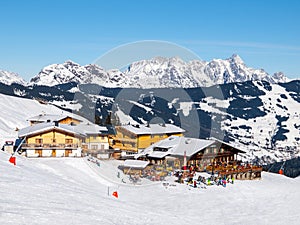 Downhill slope and apres ski mountain hut with restaurant terrace in Saalbach Hinterglemm Leogang winter resort, Tirol