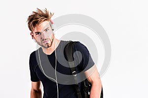 Download music application. Man tousled hairstyle wear plastic earphones gadget. Student handsome guy listening music
