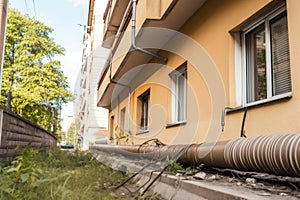 downpipe being replaced with new, modern pipe in residential area