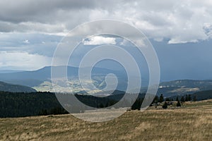 Downpour over mountain with gloomy clouds