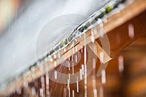 Downpour in the summer storm and rain drops on the roof