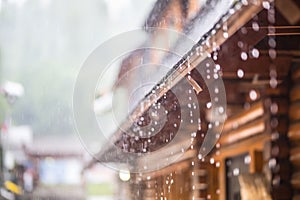 Downpour in the summer storm and rain drops on the roof