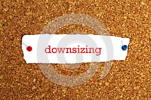 Downsizing word on white paper