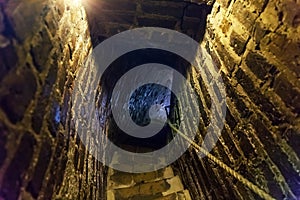 Downstairs in ancient stone tower tunnel