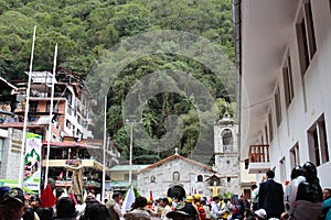 Downtown Aguas Calientes filled with Peruvians waiting for a parade with the Virgen Del Carmen Church