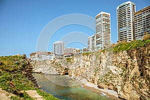Downtown buildings and towers with rocks and sea in the foreground, Beirut, Lebanon