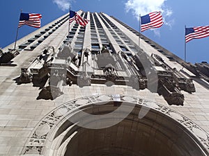 Downtown Chicago skyscraper with American flags view from below