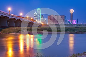 Downtown Dallas, Texas skyline at night reflecting in Trinity Ri