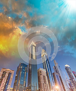 Downtown Dubai skyscrapers at night, skyward view