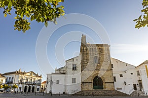 Downtown of Faro with Se Cathedral in the morning with orange tree in the foreground, Portugal