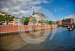 Downtown Hamburg on a cloudy day. Boats passing on the waterways.