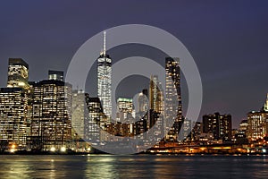 Downtown Manhattan at night with the new World Trade Center and East River photo