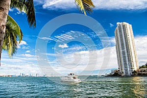 Downtown Miami along Biscayne Bay with condos and office buildings, yacht sailing in the bay