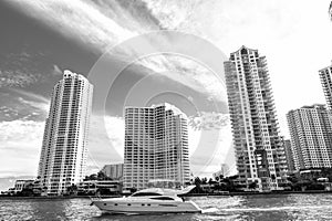 Downtown Miami along Biscayne Bay with condos and office buildings, yacht sailing in the bay