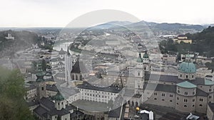 Downtown of Salzburg city in Austria, top view from Hohensalzburg Fortress on a cloudy sommer day.