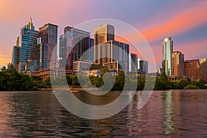 Downtown Skyline of Austin, Texas in USA. Austin Sunset on the Colorado River. Night sunset city. Reflection in water.