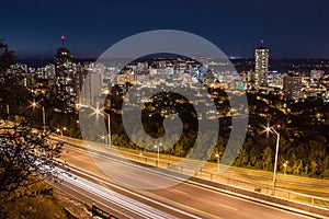 Downtown skyline and light trails from cars at night in Hamilton, Ontario photo