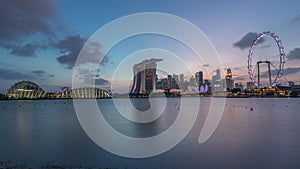 Downtown skyline of Singapore as viewed from across the water from The Garden East day to night timelapse. Singapore.