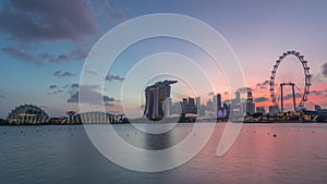 Downtown skyline of Singapore as viewed from across the water from The Garden East day to night timelapse. Singapore.