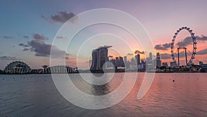 Downtown skyline of Singapore as viewed from across the water from The Garden East day to night timelapse. Singapore.