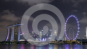 Downtown skyline of Singapore as viewed from across the water from The Garden East night timelapse hyperlapse. Singapore