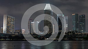 Downtown skyline of Singapore as viewed from across the water from The Garden East night timelapse. Singapore.