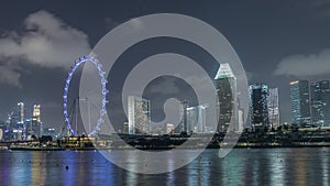 Downtown skyline of Singapore as viewed from across the water from The Garden East night timelapse. Singapore.