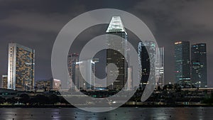 Downtown skyline of Singapore as viewed from across the water from The Garden East night timelapse. Singapore.