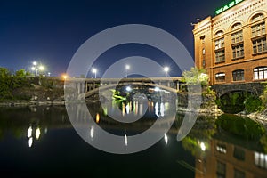 Downtown Spokane Washington at Riverfront Park and the river at night.