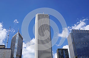 Downtown, Tall light building in the center. Blue sky with white clouds behind
