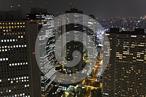 Downtown Tokyo financial district by night aerial with light in office